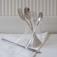 Luxury stainless steel flatware set styled with elegant dinnerware for contemporary dining.