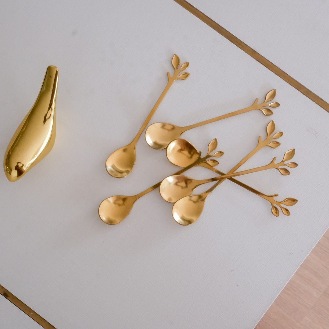 Gold coffee spoons featuring artistic leaf design for everyday and festive dining