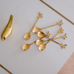 Gold coffee spoons featuring artistic leaf design for everyday and festive dining