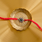 silver flower rakhi with a pink stone and traditional braided thread, ideal premium Raksha Bandhan rakhi for brothers.