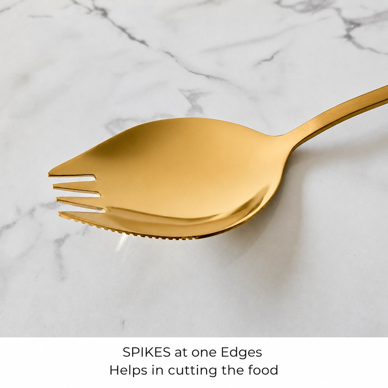 A gold-colored spork with serrated edges on a white marble background, with a text overlay at the bottom explaining its design.