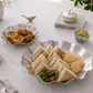 Large hammered stainless steel serving platter with assorted tea sandwiches and potato chips, paired with a matching snack bowl for elegant home entertainment