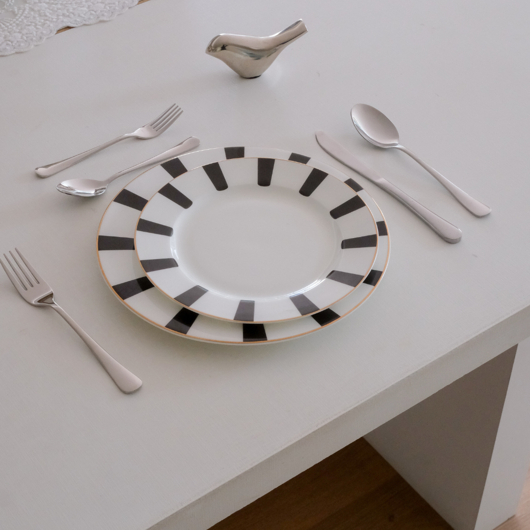 Dining table cutlery on a white table