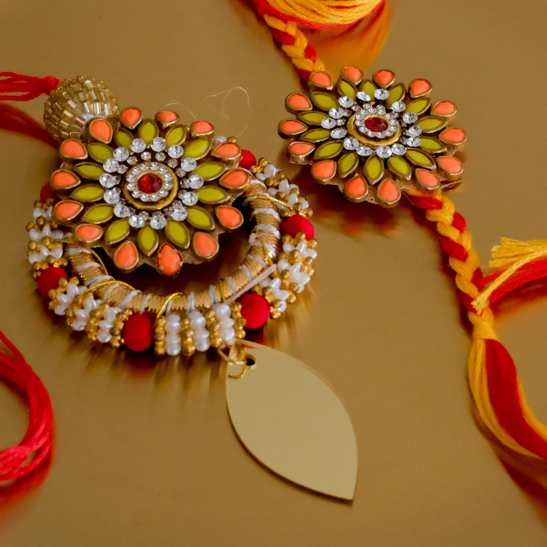 Beautiful floral rakhi combo for Bhai and Bhabhi featuring premium craftsmanship and festive colors.