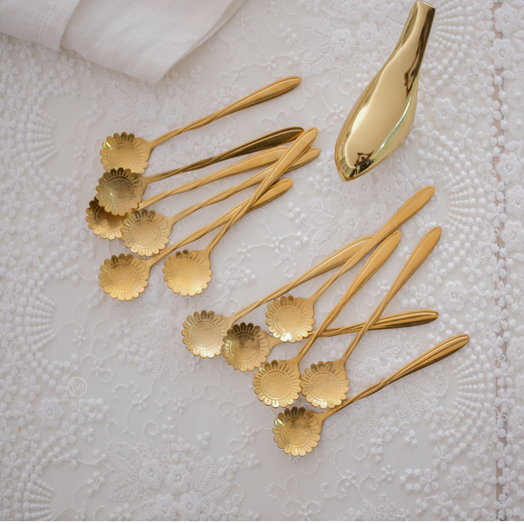 Luxury gold sunflower dessert spoon set on marble background