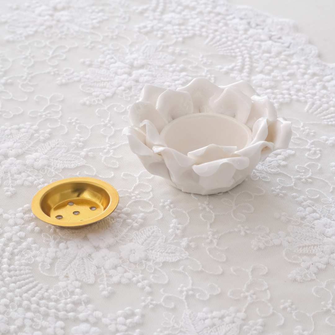 Ceramic lotus flower tea light holder with an ivory-white glazed finish
