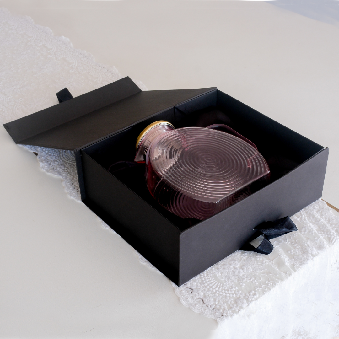 Textured pink glass jug with concentric ribbed design, gold lid and matching handle