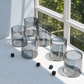 Set of 6 glasses placed on table with natural sunlight