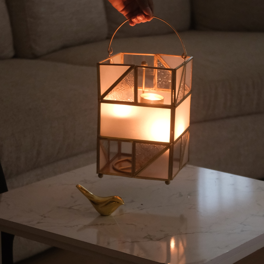 Vintage-inspired gold tea light holder with textured glass accents for elegant décor.