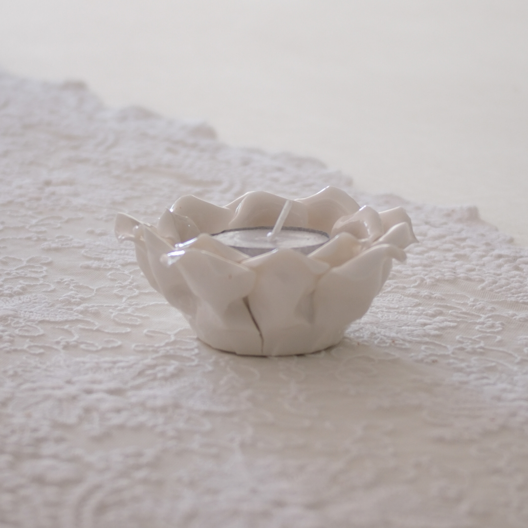 Floral-inspired white ceramic tea light holder with layered petals