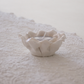 Floral-inspired white ceramic tea light holder with layered petals