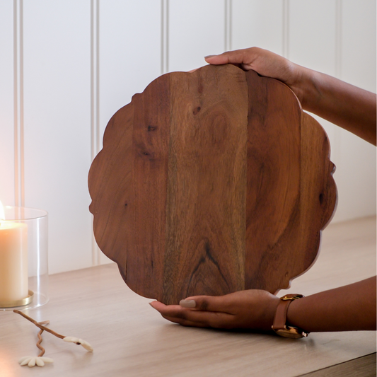 Round wooden charcuterie board for serving cheese, fruits, and appetizers.