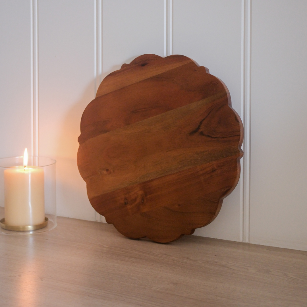 Wooden serving platter with elegant scalloped edges for stylish presentation.