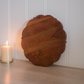 Wooden serving platter with elegant scalloped edges for stylish presentation.
