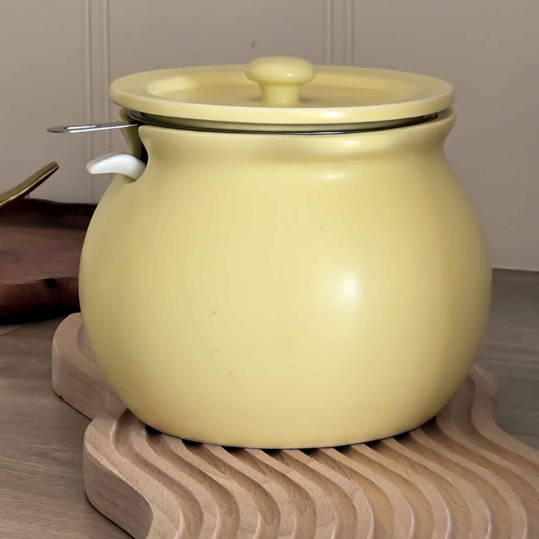 Modern yellow ceramic airtight jar for storing dry fruits, cookies, sugar and coffee.