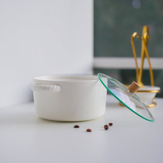Minimalist ceramic pot with transparent lid and wooden knob in bright home setting