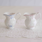 White porcelain creamer jar with pink floral print and embossed design