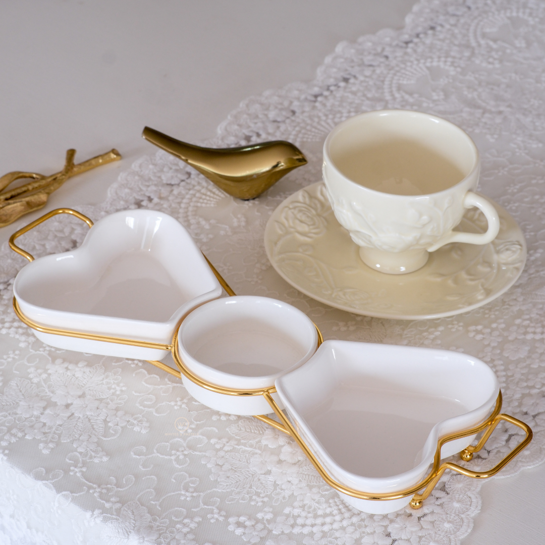 Decorative ceramic appetizer platter with heart shaped serving bowls.