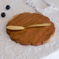 Wooden serving board with gold butter knife
