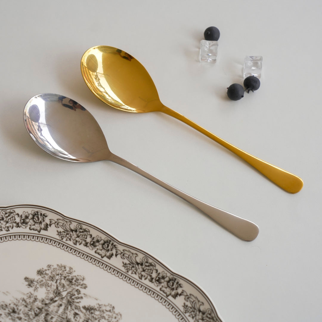 Gold and silver serving spoon