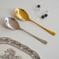 Gold and silver serving spoon