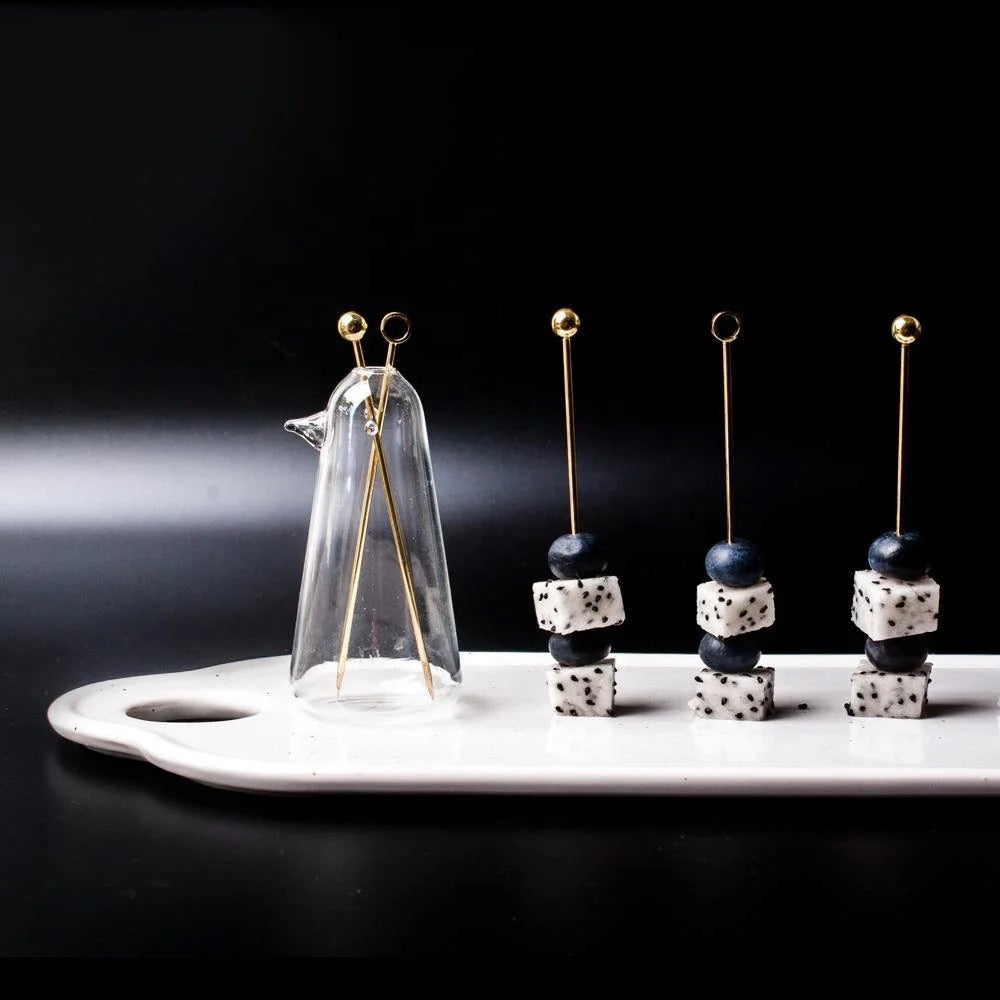 Penguin glass vase used as cocktail pick holder