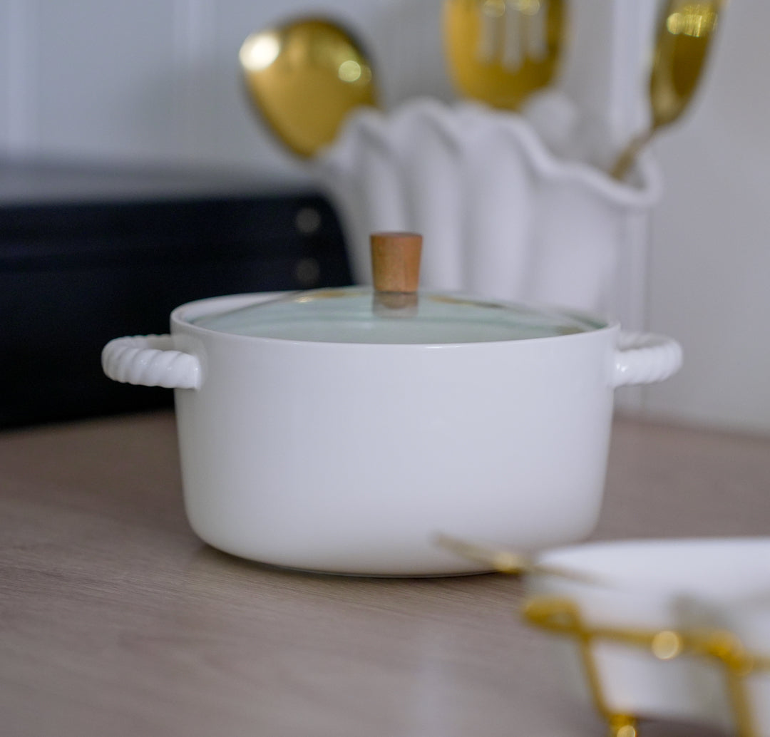 Elegant white ceramic casserole dish with glass lid and wooden top knob