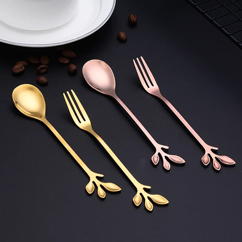 A set of dessert spoons and fruit forks with leaf designs, featuring colors rose gold and gold.